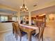 Open dining room with wood table and views of the kitchen and living room, creating a cohesive space at 12832 Sawgrass Pine Cir, Orlando, FL 32824