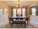 Formal dining room with a wooden table, bench seating, and elegant chandelier lighting fixture at 12832 Sawgrass Pine Cir, Orlando, FL 32824