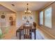 Bright dining room featuring tile flooring, bench seating, and a chandelier at 12832 Sawgrass Pine Cir, Orlando, FL 32824