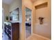Inviting hallway featuring decor niche, stylish flooring, and a glimpse into the primary bedroom at 12832 Sawgrass Pine Cir, Orlando, FL 32824
