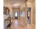 Inviting hallway with neutral paint, tile flooring, front door with glass inset, and decorative furnishings at 12832 Sawgrass Pine Cir, Orlando, FL 32824