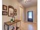 Inviting hallway features neutral colors, decor, tile flooring and an ornate table with decor at 12832 Sawgrass Pine Cir, Orlando, FL 32824