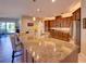 Bright kitchen with stainless steel appliances, granite countertops, and a large central island with pendant lighting at 12832 Sawgrass Pine Cir, Orlando, FL 32824