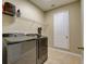 Modern laundry room equipped with a new front load washer and dryer and ample shelving space at 12832 Sawgrass Pine Cir, Orlando, FL 32824