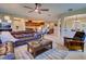 Open concept living room with seamless flow to the kitchen, a large sectional, and tile floors at 12832 Sawgrass Pine Cir, Orlando, FL 32824