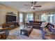 Comfortable living room with a large sectional sofa, fireplace, and ample natural light at 12832 Sawgrass Pine Cir, Orlando, FL 32824