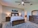 Comfortable main bedroom offering wood flooring, a ceiling fan, and access to the bathroom at 12832 Sawgrass Pine Cir, Orlando, FL 32824