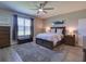 The main bedroom features a ceiling fan, area rug, and a large window for lots of light at 12832 Sawgrass Pine Cir, Orlando, FL 32824
