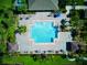 Aerial view of community pool surrounded by lush landscaping and seating areas at 12832 Sawgrass Pine Cir, Orlando, FL 32824