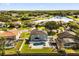 An aerial view of a home with a pool and lake community in the background at 14524 Huntingfield Dr, Orlando, FL 32824