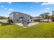 Spacious backyard with a pool, patio, gazebo, and a lush green lawn at 14524 Huntingfield Dr, Orlando, FL 32824
