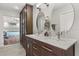 Bathroom with a double vanity, marble countertops, and storage cabinets at 14524 Huntingfield Dr, Orlando, FL 32824