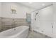 Bright bathroom featuring a standalone tub and modern walk-in shower at 14524 Huntingfield Dr, Orlando, FL 32824