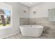 Bright bathroom featuring a standalone tub and modern fixtures at 14524 Huntingfield Dr, Orlando, FL 32824