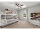 Bright bedroom with a bunk bed, ceiling fan, and a window offering natural light at 14524 Huntingfield Dr, Orlando, FL 32824