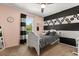 Charming bedroom with black and white accents, complemented by a ceiling fan and a bright window at 14524 Huntingfield Dr, Orlando, FL 32824