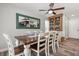 Dining room with wood-look tile, a table set for six, a ceiling fan, and a built-in cabinet at 14524 Huntingfield Dr, Orlando, FL 32824