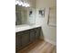 Bathroom with tiled floors, grey vanity, and framed mirror at 152 Glendale Ct, Kissimmee, FL 34759
