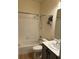 Bathroom with a white tiled shower-tub combination and a modern vanity at 152 Glendale Ct, Kissimmee, FL 34759
