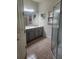 Bathroom with tiled floors, grey vanity, and framed mirror at 152 Glendale Ct, Kissimmee, FL 34759