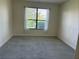 Carpeted bedroom with large window at 152 Glendale Ct, Kissimmee, FL 34759