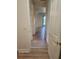 Hallway with wood-look flooring connecting various rooms, creating a cohesive layout at 152 Glendale Ct, Kissimmee, FL 34759