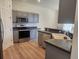 Modern kitchen with stainless steel appliances and gray cabinets at 152 Glendale Ct, Kissimmee, FL 34759