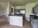 Bright kitchen featuring stainless steel appliances, gray cabinetry and stone countertops at 152 Glendale Ct, Kissimmee, FL 34759