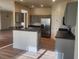 Bright kitchen with stainless steel refrigerator, central island, and updated cabinets at 152 Glendale Ct, Kissimmee, FL 34759