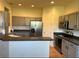 Open kitchen with stainless steel appliances, gray cabinets and breakfast bar at 152 Glendale Ct, Kissimmee, FL 34759