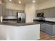 Modern kitchen featuring stainless steel appliances, gray cabinets and breakfast bar at 152 Glendale Ct, Kissimmee, FL 34759