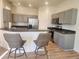 Modern kitchen featuring stainless steel appliances, gray cabinets, and breakfast bar with seating at 152 Glendale Ct, Kissimmee, FL 34759