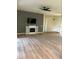 Spacious living room features laminate wood flooring and a decorative fireplace at 152 Glendale Ct, Kissimmee, FL 34759