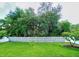 Spacious backyard with green lawn, mature trees and white picket fence at 1588 Diamond Loop Drive, Kissimmee, FL 34744