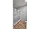 Modern bathroom featuring gray and white marble tile, a frameless glass shower and wood-look flooring at 1588 Diamond Loop Drive, Kissimmee, FL 34744