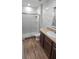 Modern bathroom with white marble tile, glass shower, and updated vanity at 1588 Diamond Loop Drive, Kissimmee, FL 34744