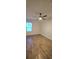 Minimalist bedroom with wood-look flooring, a ceiling fan and a window at 1588 Diamond Loop Drive, Kissimmee, FL 34744