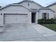 Charming single-story home with a gray exterior, a two-car garage and a well maintained driveway at 1588 Diamond Loop Drive, Kissimmee, FL 34744