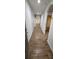 Hallway featuring wood-look flooring, arched doorways and neutral paint at 1588 Diamond Loop Drive, Kissimmee, FL 34744