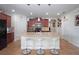 Open-concept kitchen with an island, pendant lighting, wood cabinets and stainless steel appliances at 1588 Diamond Loop Drive, Kissimmee, FL 34744