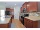 Spacious kitchen with wood cabinets, stainless steel appliances, and a stylish backsplash at 1588 Diamond Loop Drive, Kissimmee, FL 34744