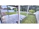 Cozy patio with view of lush backyard, white fence and mature trees at 1588 Diamond Loop Drive, Kissimmee, FL 34744