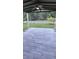 Covered patio featuring ceiling fan and spacious backyard with white picket fence at 1588 Diamond Loop Drive, Kissimmee, FL 34744