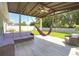 Enjoy the covered patio with fan, hammock, wicker furniture, and spacious backyard at 1588 Diamond Loop Drive, Kissimmee, FL 34744