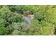 Aerial view highlighting the home surrounded by mature trees, creating a private and serene atmosphere at 15888 Ne 152Nd Ave, Fort Mc Coy, FL 32134