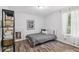 Well-lit bedroom with wood-look floors, a map, and a cozy single bed at 15888 Ne 152Nd Ave, Fort Mc Coy, FL 32134