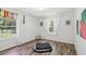 Bright bedroom featuring two windows and a comfortable pet bed at 15888 Ne 152Nd Ave, Fort Mc Coy, FL 32134