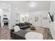 Spacious living room with a sectional sofa, hardwood floors, and a view of the adjacent kitchen at 15888 Ne 152Nd Ave, Fort Mc Coy, FL 32134