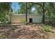 Exterior view of the outbuilding with a metal roof and surrounding foliage at 15888 Ne 152Nd Ave, Fort Mc Coy, FL 32134