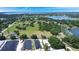 Aerial view of wooded land featuring residential development, lakes and agricultural buildings at 17927 E Apshawa Rd, Minneola, FL 34715